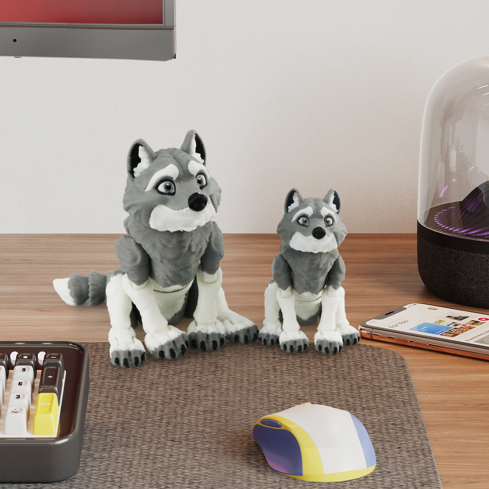Gray articulated husky 3D printed toy family sitting on a desk