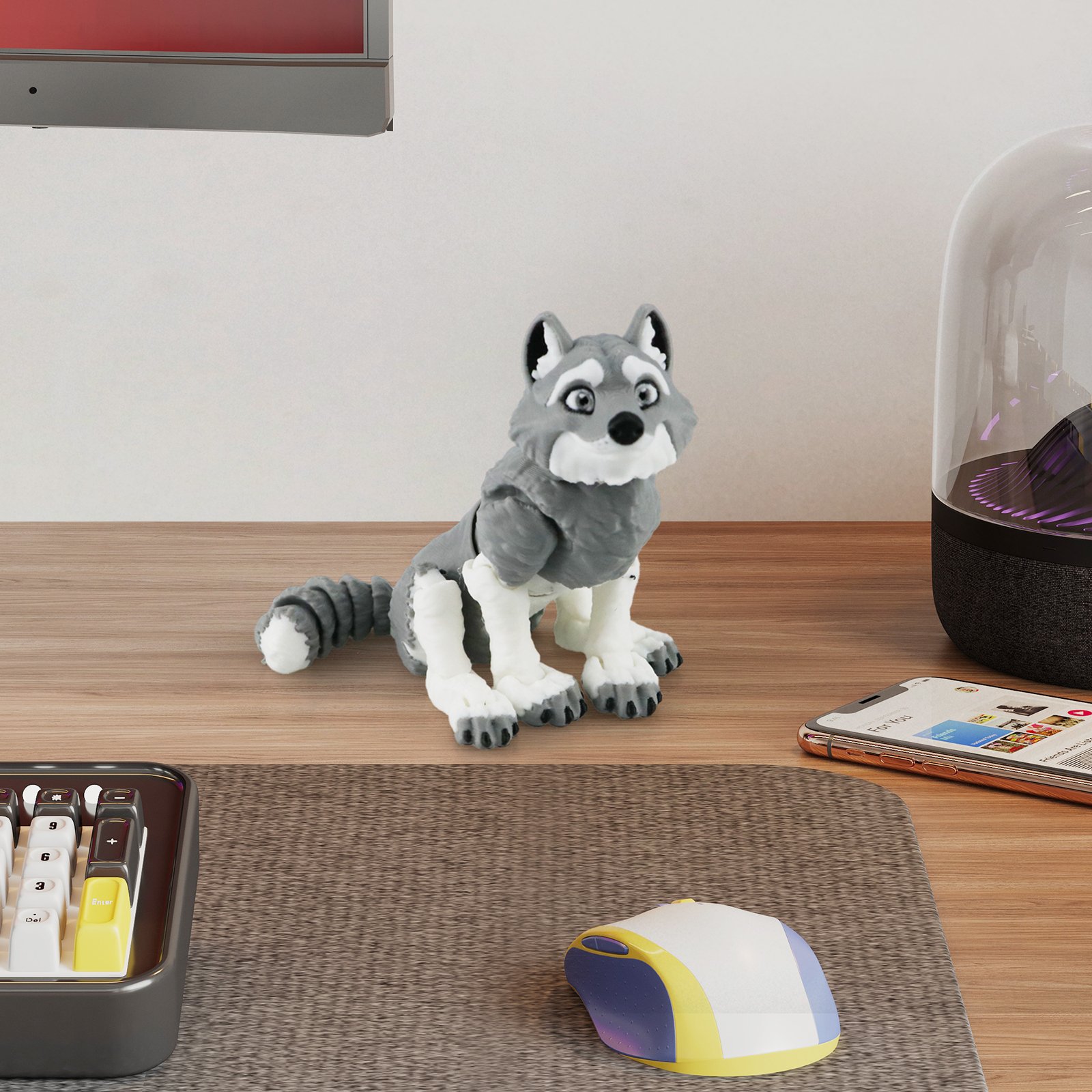 Gray articulated husky 3D printed toy sitting on a desk