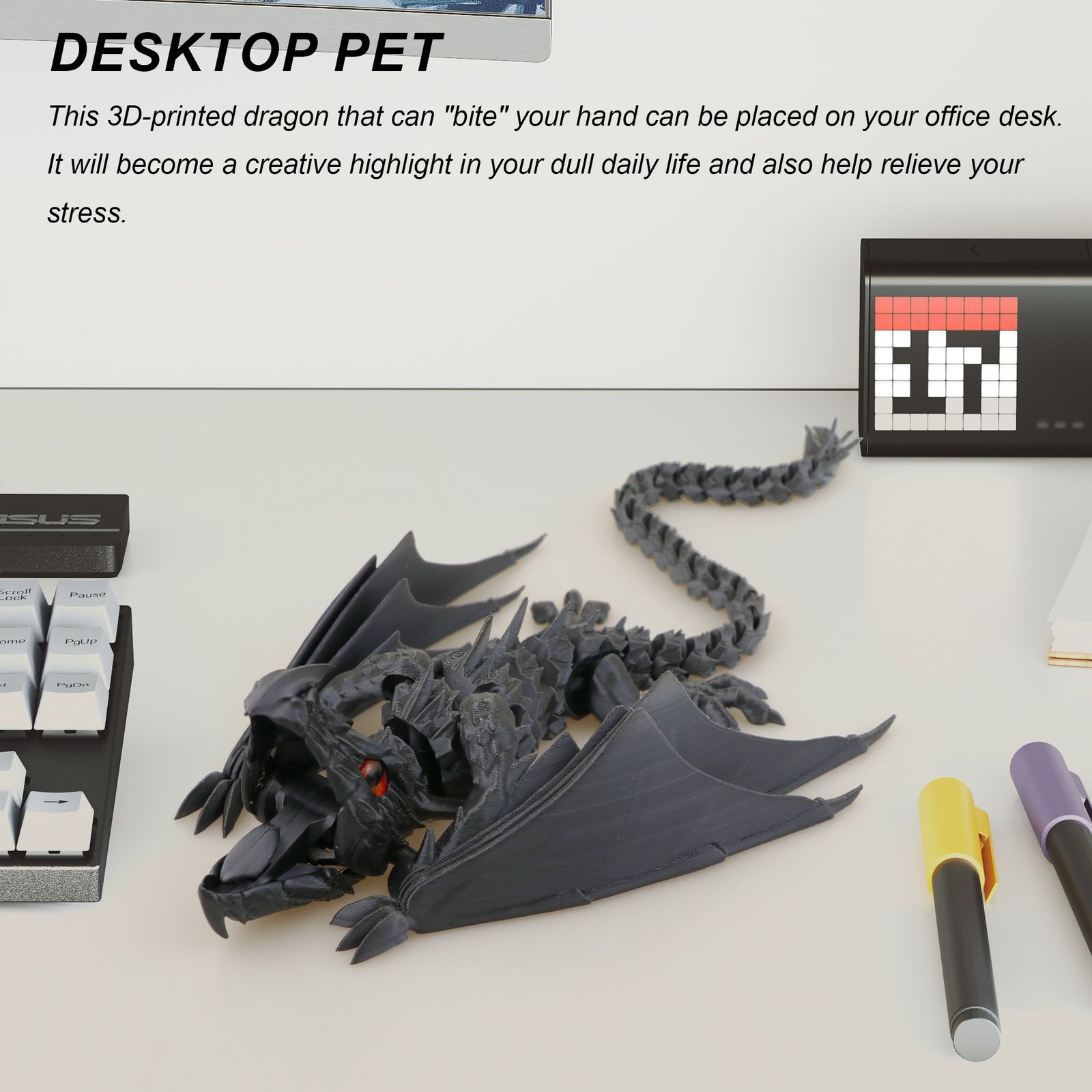 Black articulated dragon 3D printed toy on a desk